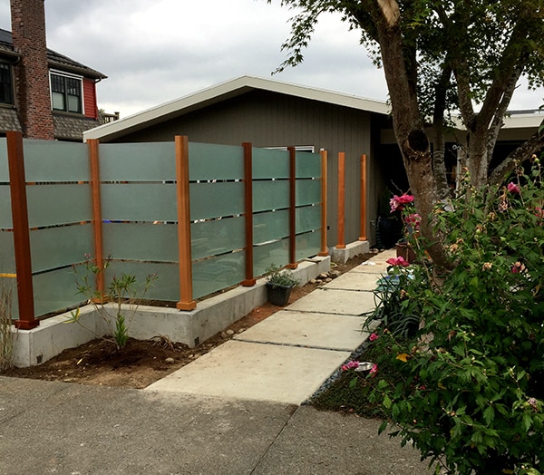 Creative fence using glass and wood.