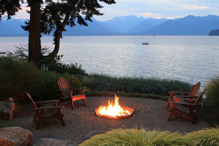 A Dan Blossom beachscape with a fire pit